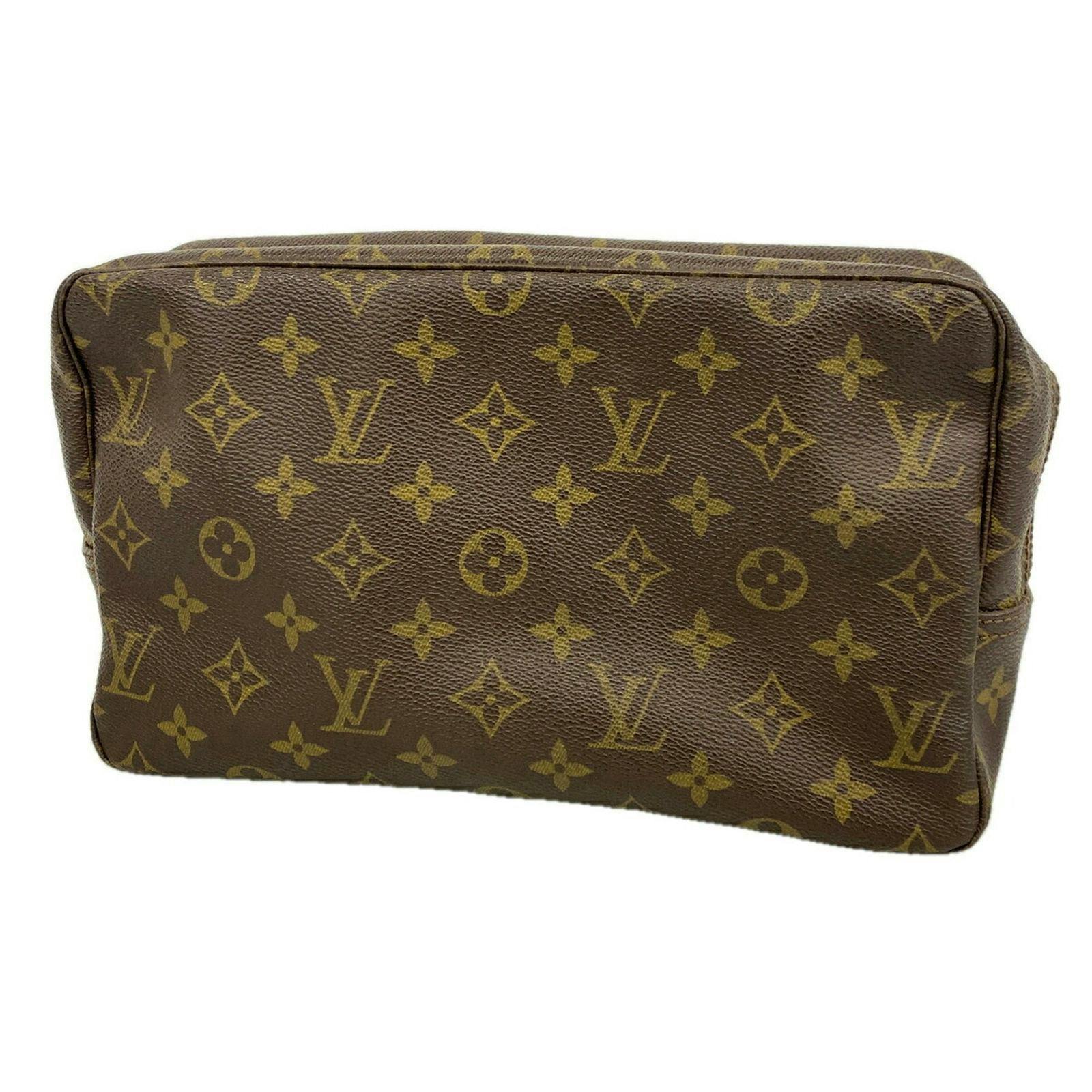 Close-up front view of the Louis Vuitton monogram pouch in brown.