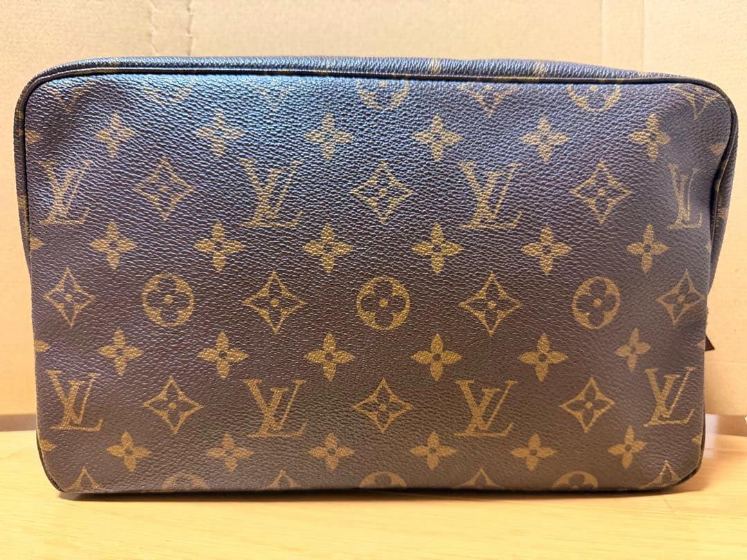 Front view of the Louis Vuitton monogram pouch showing the brown LV monogram pattern.