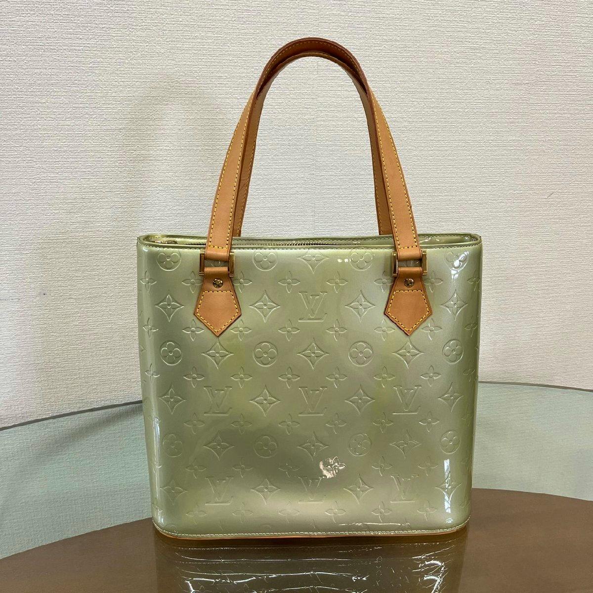 Front view of a green Louis Vuitton Monogram Vernis Houston patent leather tote bag with embossed monogram and tan leather handles.