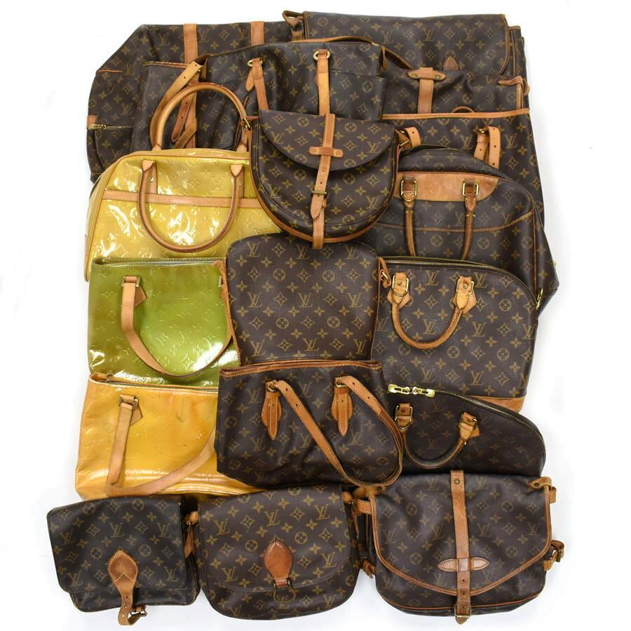 Overhead photo of a bulk set of Louis Vuitton monogram and Vernis handbags and shoulder bags arranged on a white background.