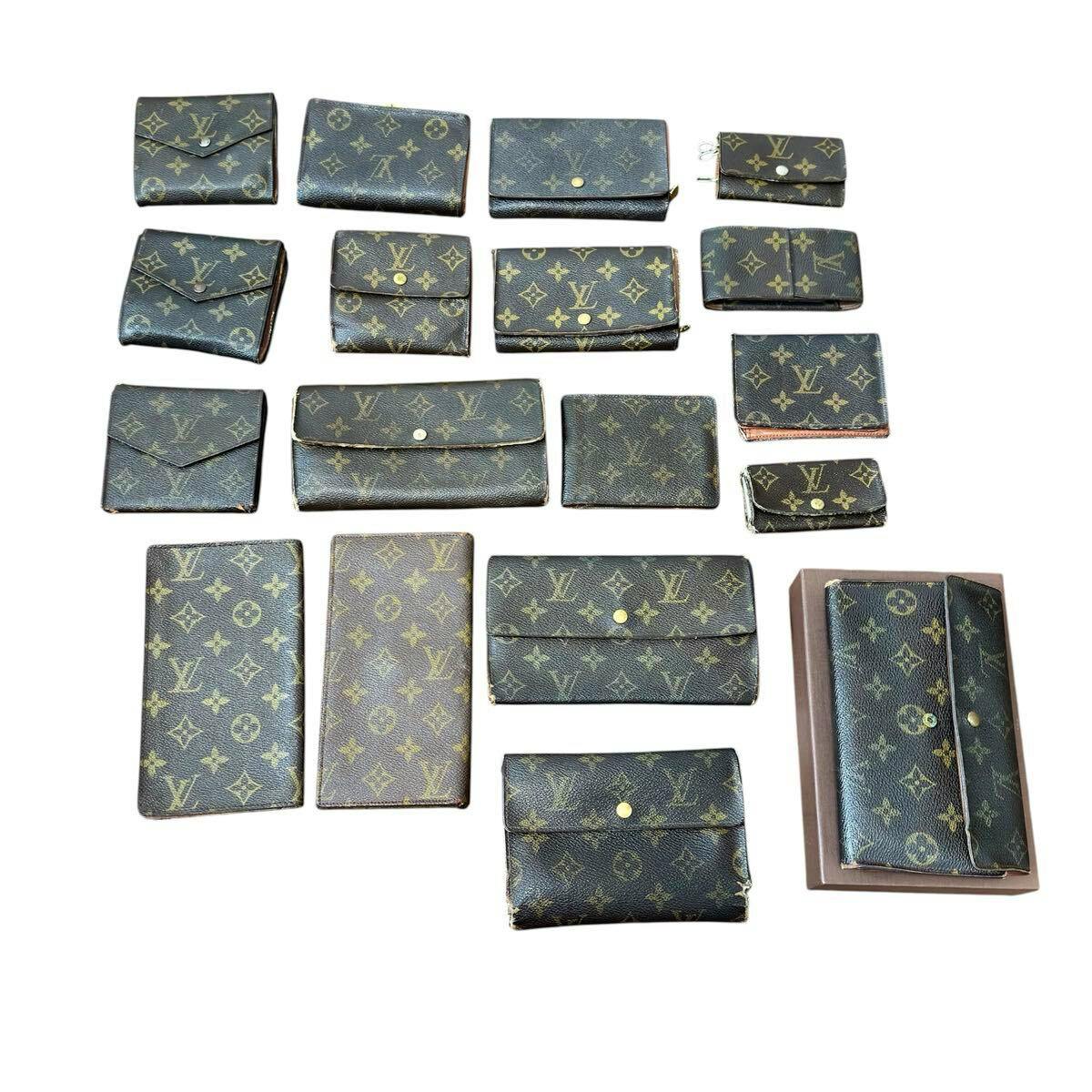 Multiple Louis Vuitton monogram wallets and key cases arranged on a white background.