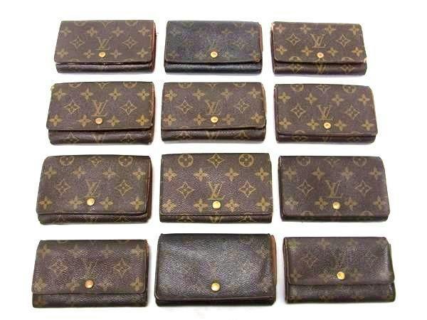 Twelve Louis Vuitton monogram two-fold wallets arranged in a grid on a white background.
