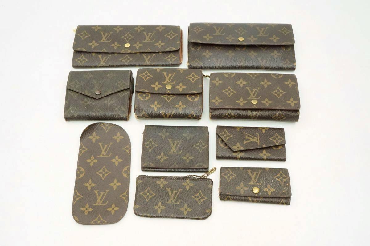 Ten Louis Vuitton monogram wallets, coin cases, and key cases arranged on a white background.