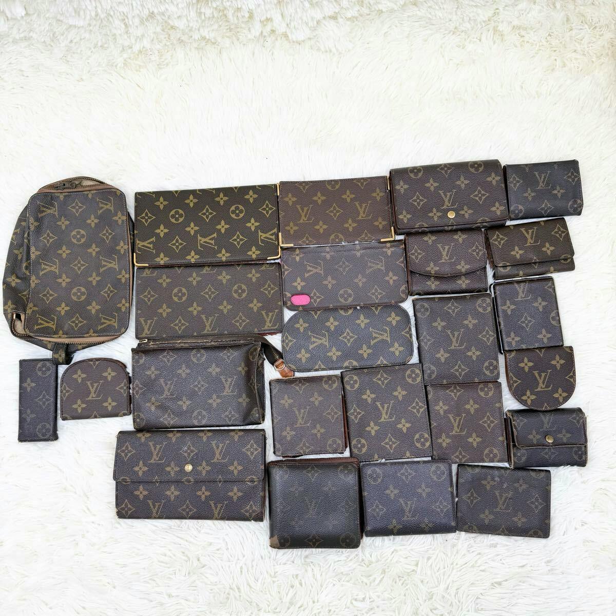 Several Louis Vuitton monogram wallets and small leather accessories arranged on a white surface.