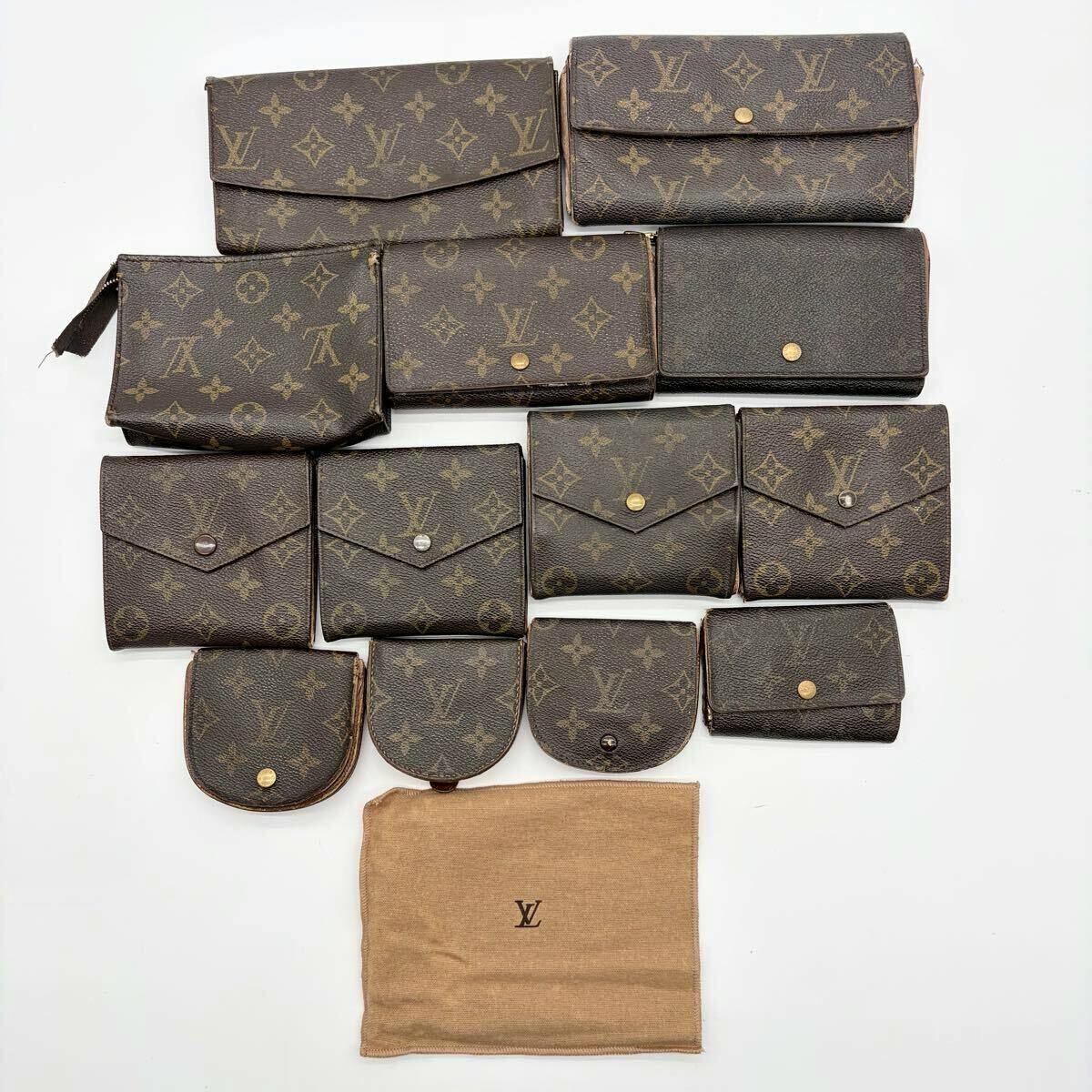 Top-down photo of multiple Louis Vuitton monogram canvas wallets, coin purses, and small pouches arranged with a beige Louis Vuitton dust bag on a white background.