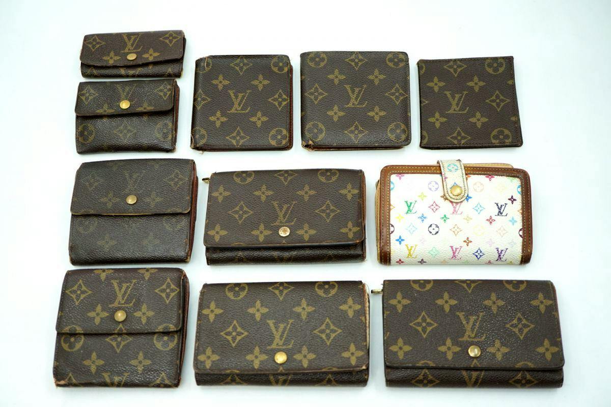 Multiple Louis Vuitton monogram wallets and small leather goods arranged on a white background.
