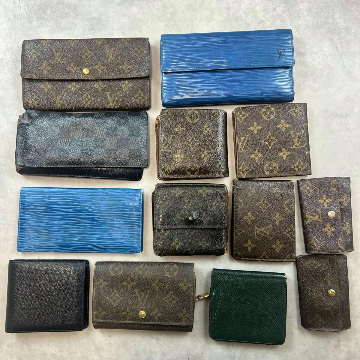 Thirteen Louis Vuitton wallets and small leather goods arranged on a light background, showing monogram and blue/green pieces with visible wear.