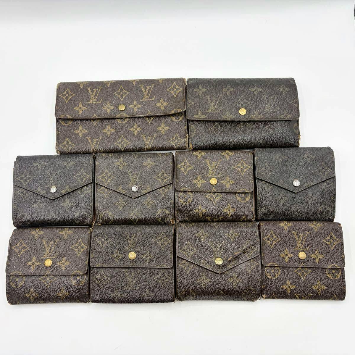 Ten Louis Vuitton monogram canvas wallets arranged on a white background.