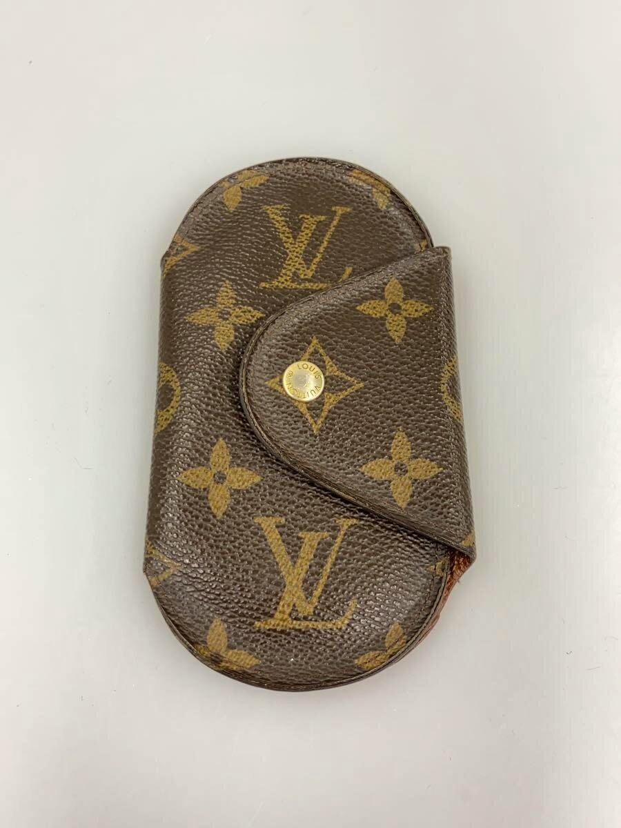 Brown Louis Vuitton monogram canvas key pouch with flap and gold snap photographed on a white background.