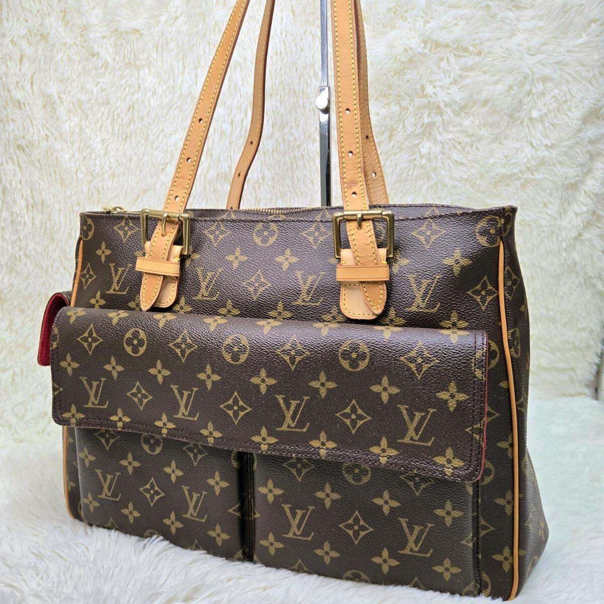 Louis Vuitton monogram handbag with tan leather shoulder straps and a front flap pocket.