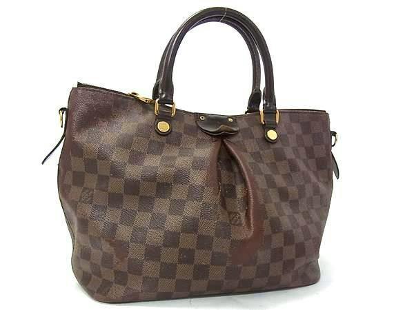 Front view of a brown Louis Vuitton Damier Siena MM tote handbag with rolled handles on a white background.