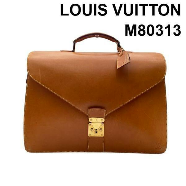 Camel leather Louis Vuitton Nomade Atacama briefcase (M80313) with top handle and gold-tone lock on a white background.