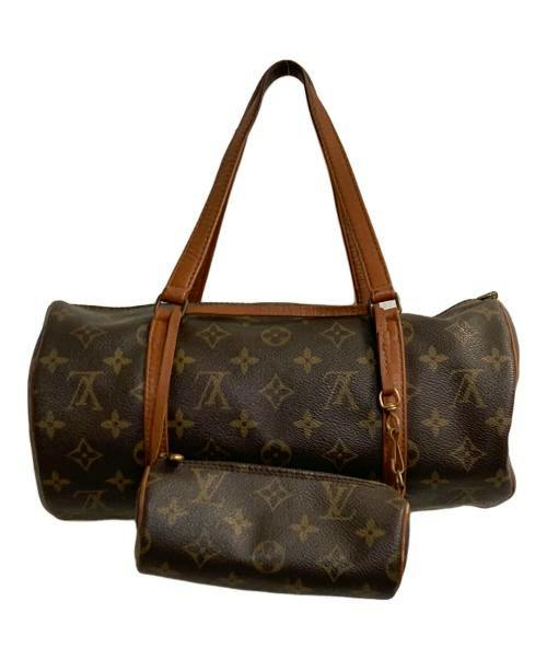 Front view of the Old Monogram Papillon 30 handbag showing the cylindrical monogram canvas body with leather handles and a small attached pouch.