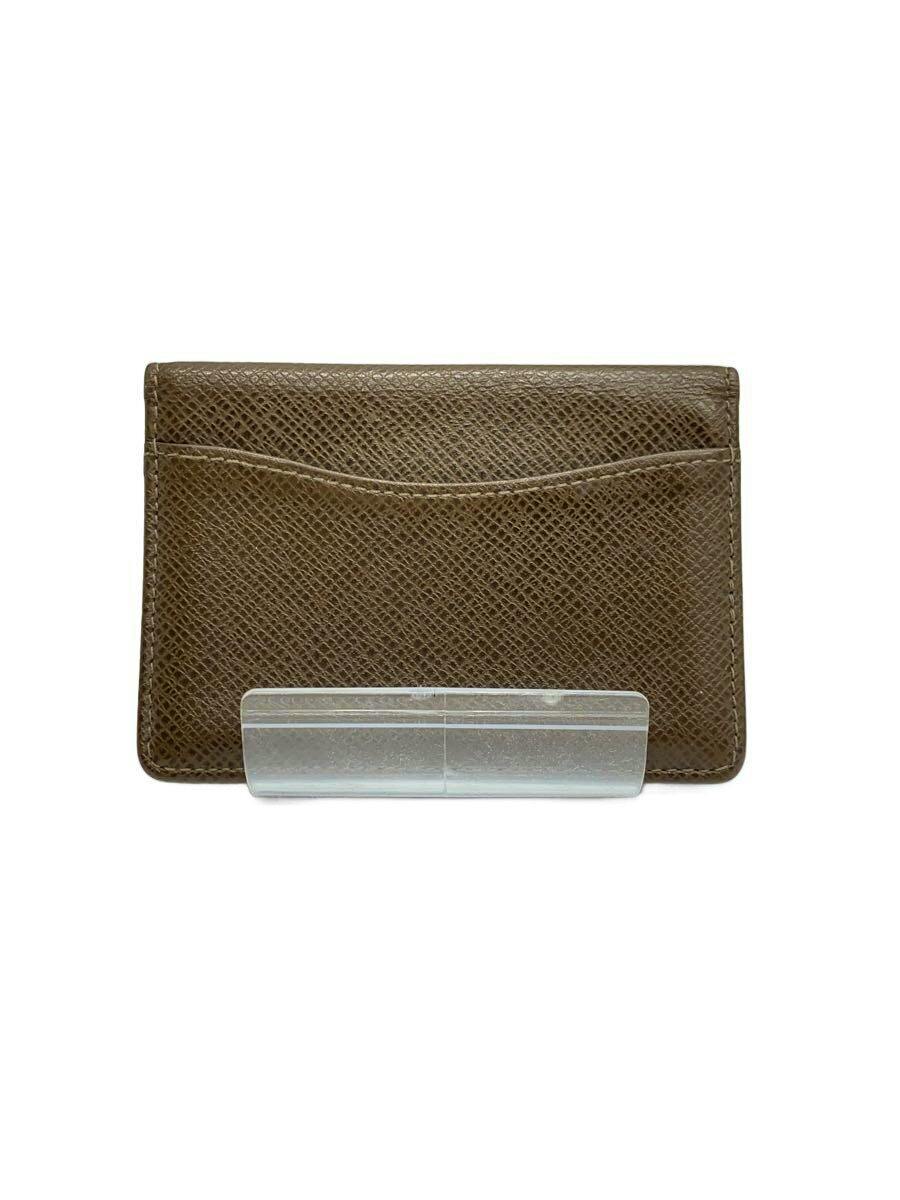 Brown leather Louis Vuitton organizer wallet shown from the back on a clear stand against a white background.