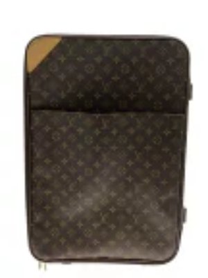 Front view of a brown Louis Vuitton monogram suitcase with a leather corner patch and an exterior front pocket.