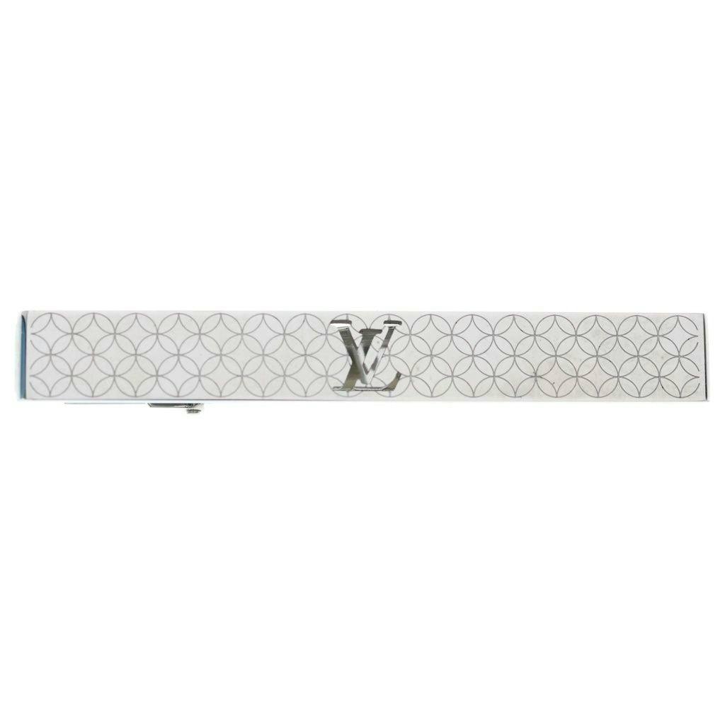 Silver tie pin showing the Louis Vuitton LV logo and a repeating circular pattern.