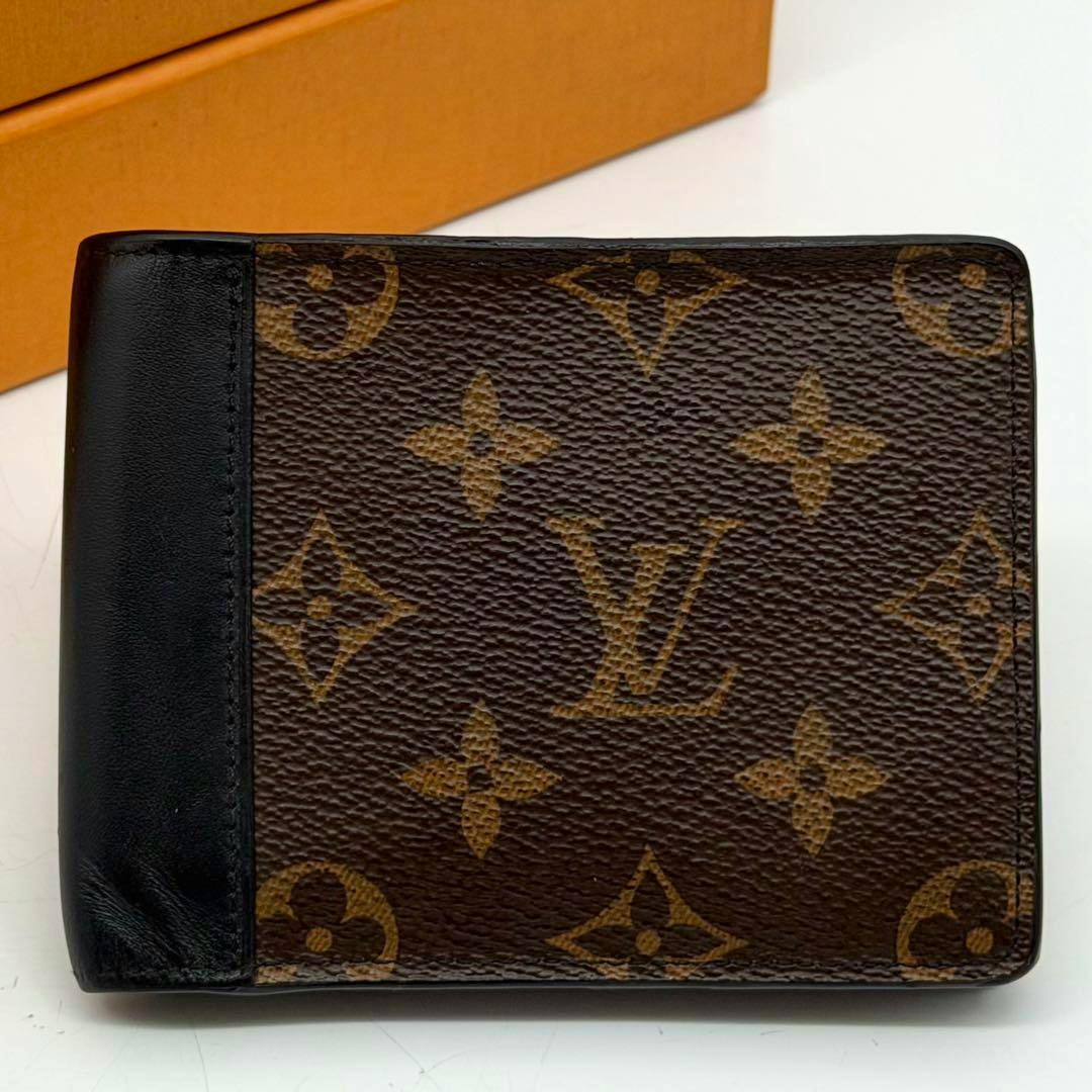 Front view of the Louis Vuitton Portefeuille Multiple Macassar monogram canvas wallet with black leather trim.