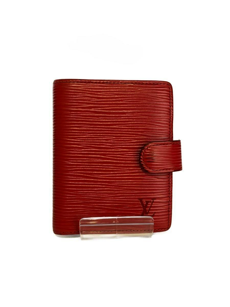 Front view of a red Louis Vuitton cow leather card case with snap closure on a white background.