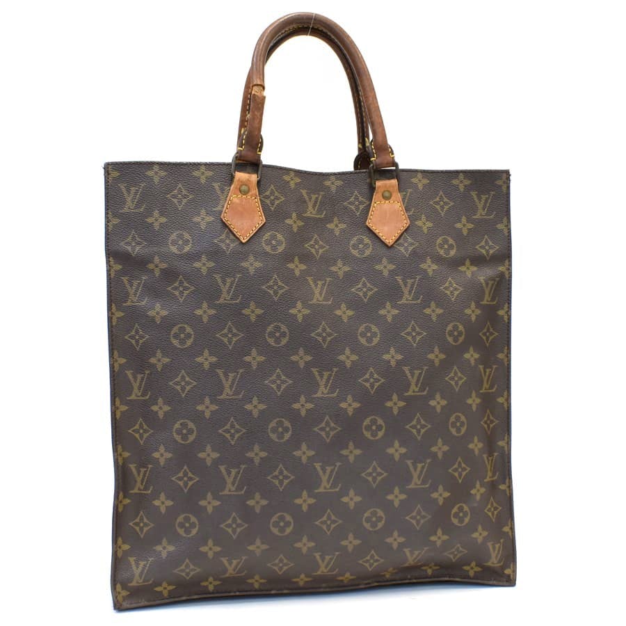 Front view of a brown Louis Vuitton monogram canvas Sac Plat handbag with two top handles.