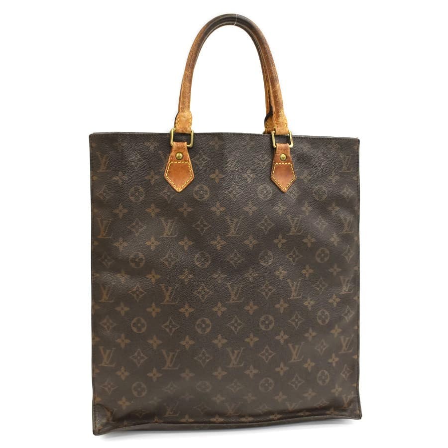 Front view of a Louis Vuitton monogram canvas tote bag with leather handles.