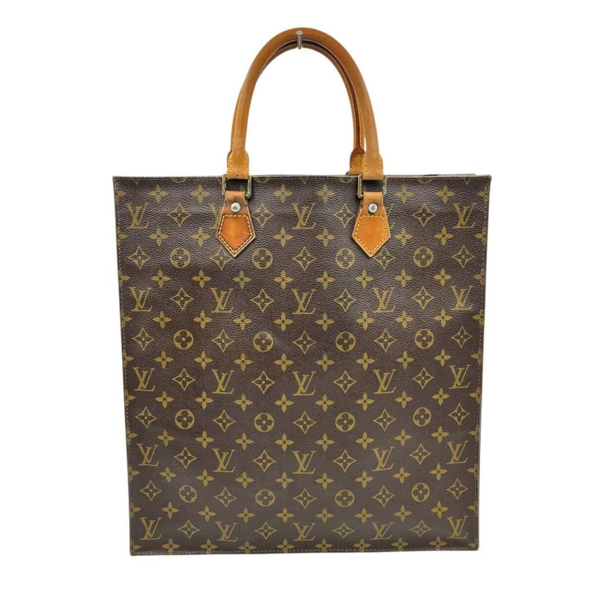 Front view of the Louis Vuitton monogram-canvas tote bag showing the rectangular body and leather top handles.