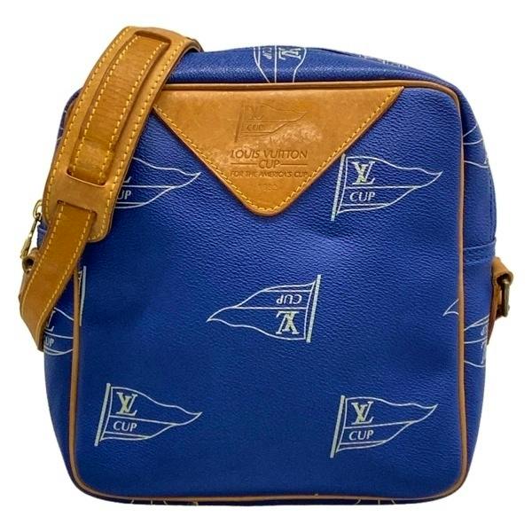 Front view of a blue Louis Vuitton Sac San Diego shoulder bag (M80010) with LV Cup flag print, brown leather trim, and an adjustable shoulder strap.