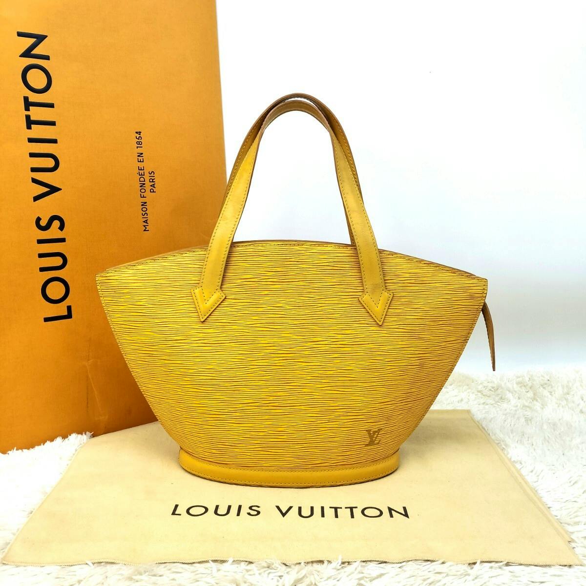 Yellow Louis Vuitton Épi San Jacque tote handbag displayed upright on a Louis Vuitton dust bag with the Louis Vuitton box in the background.