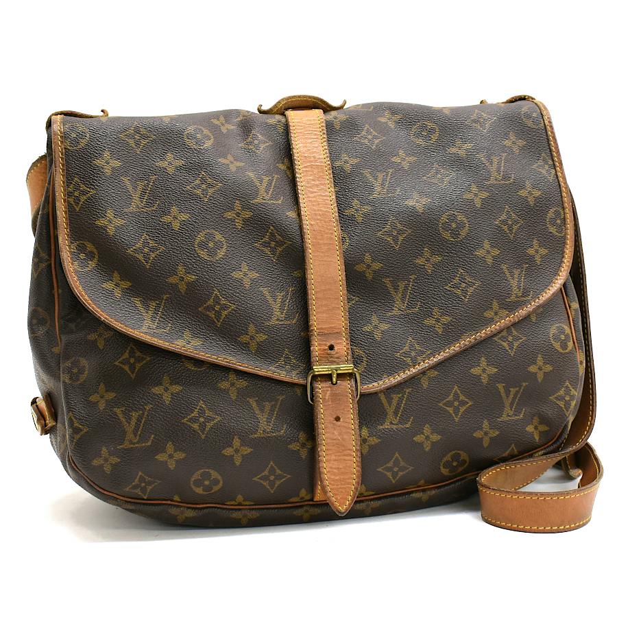 Front view of a Louis Vuitton Monogram canvas Sommeur35 shoulder bag in brown with leather trim, flap, and center buckle.