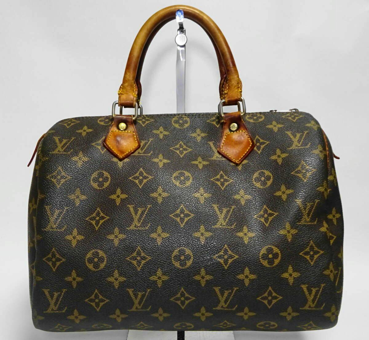 Front view of the Louis Vuitton Monogram Speedy 30 handbag with leather handles and monogram canvas.