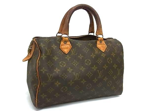 Three-quarter view of a brown Louis Vuitton Monogram Speedy 30 Boston bag with patinated leather handles.