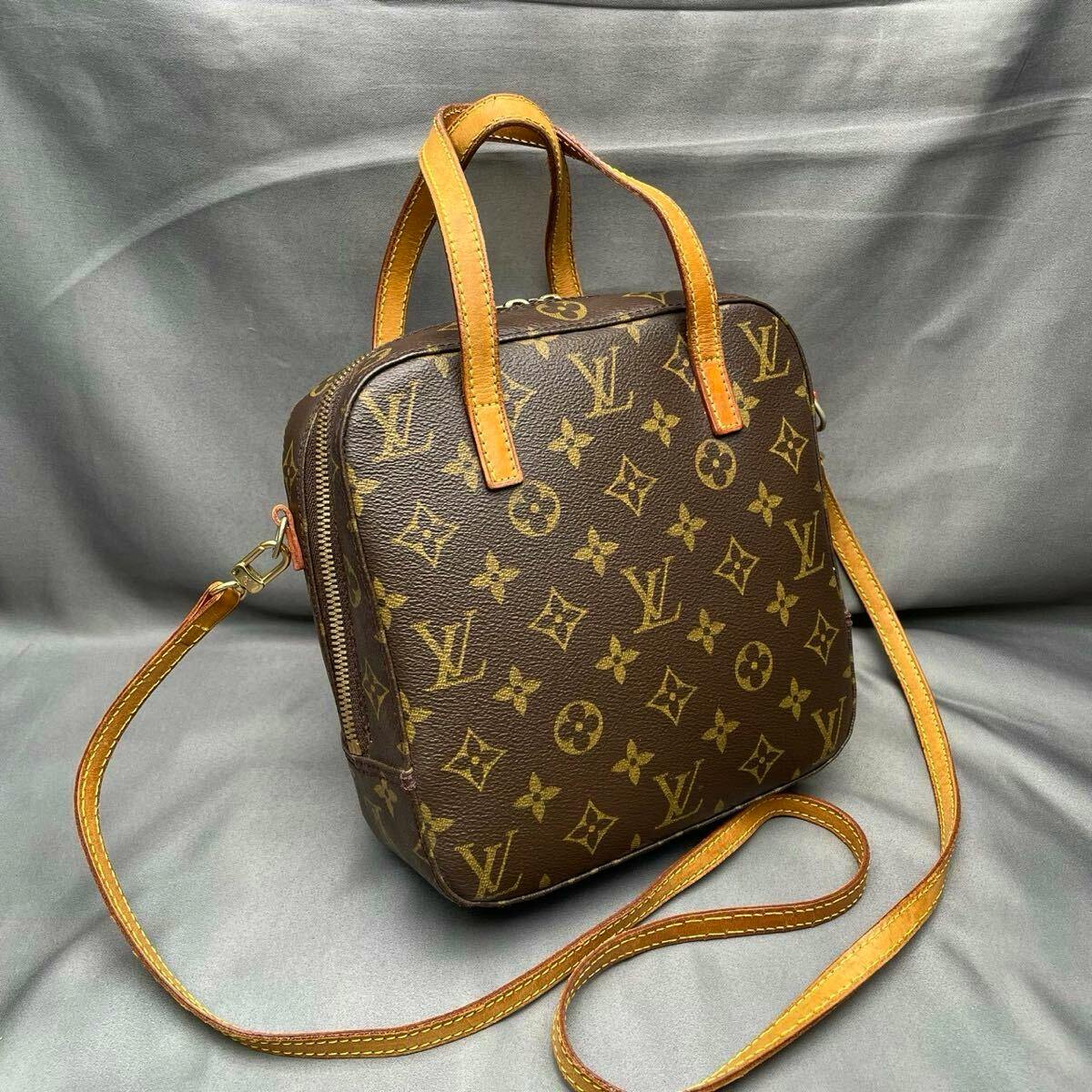Front view of the Louis Vuitton Monogram Spontini M47500 2-way shoulder/handbag with leather handles and long strap.