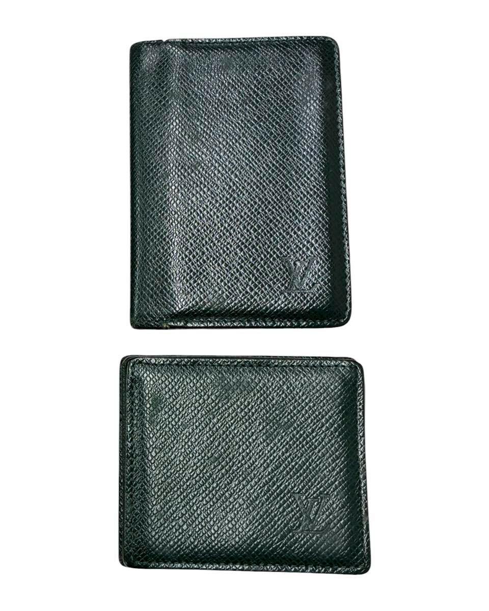 Two Épicéa green Louis Vuitton Taiga pieces (coin case and card case) shown front view with embossed LV logo.