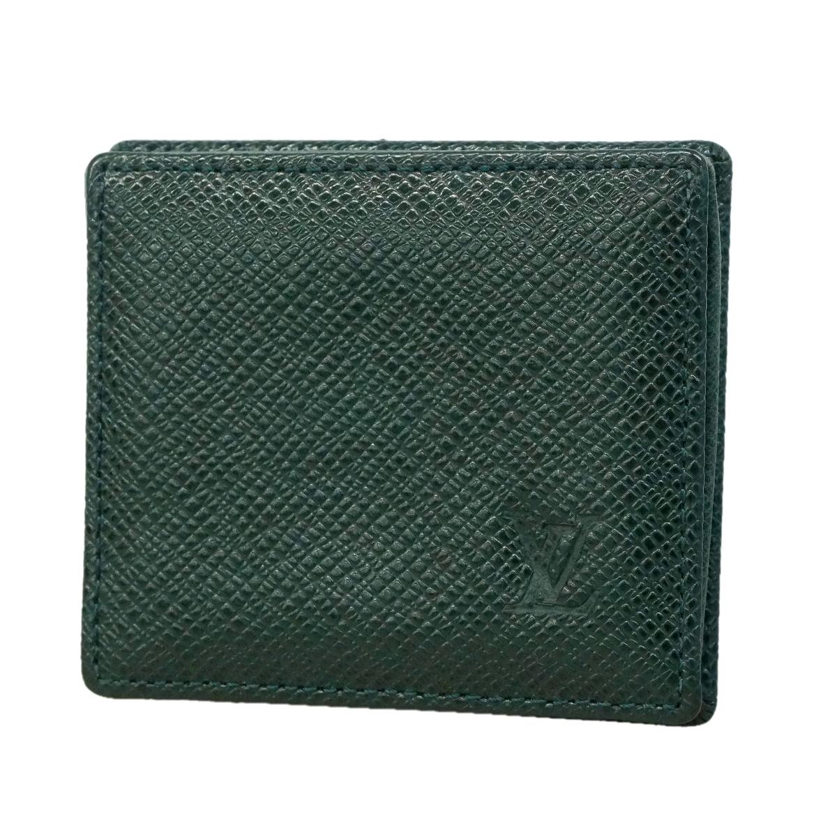 Close-up front view of the Épicéa Taiga leather Louis Vuitton coin case showing the embossed LV logo.