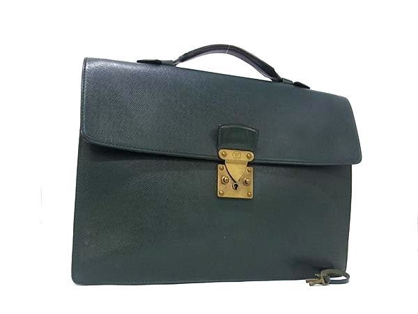 Green Louis Vuitton leather briefcase with a top handle and gold-tone lock on a white background.