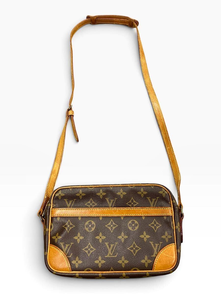 Front view of the Louis Vuitton monogram canvas shoulder bag with leather trim and a long adjustable strap.