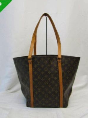 Brown Louis Vuitton monogram canvas tote bag with leather shoulder straps photographed against a plain background.