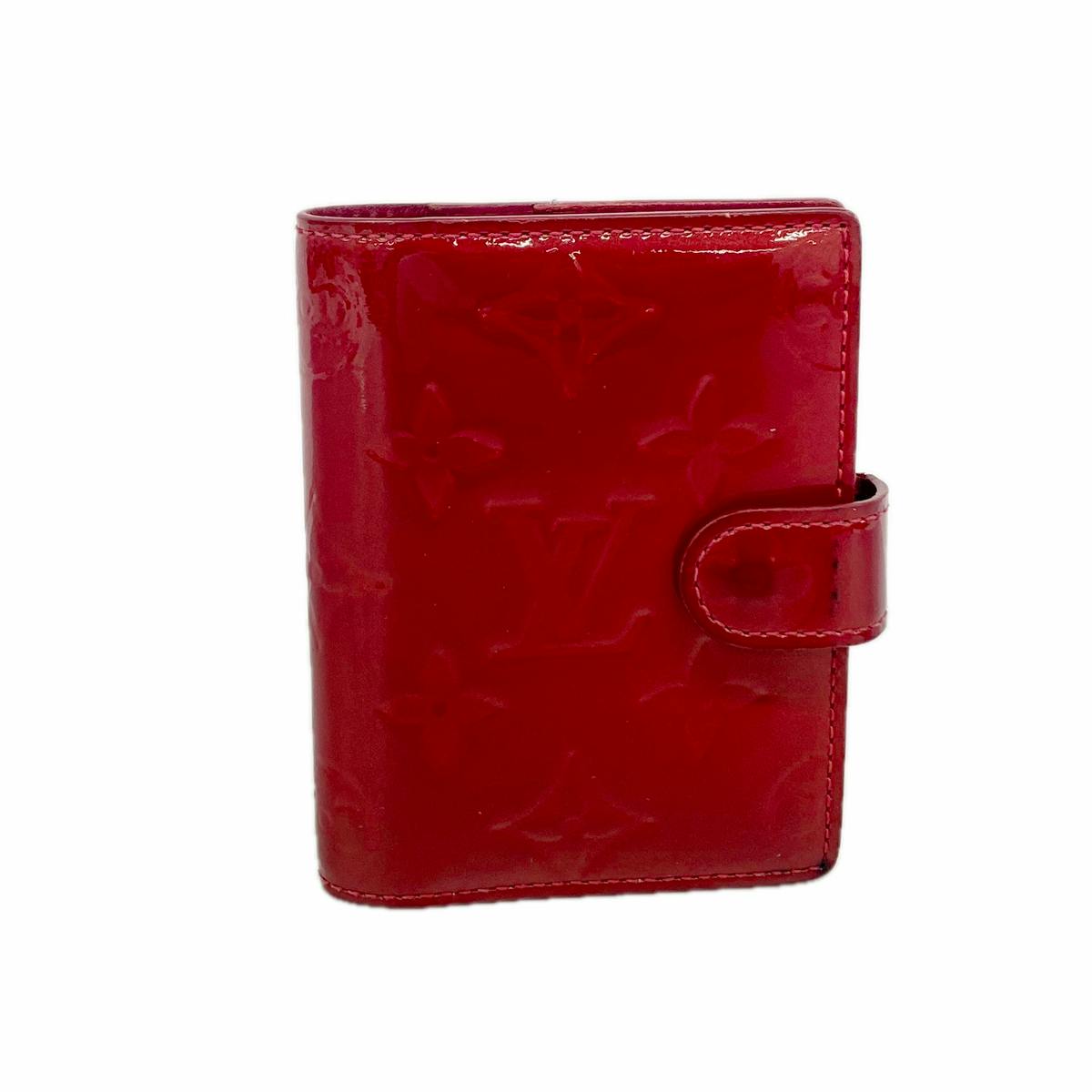 Red Louis Vuitton Vernis agenda mini cover with embossed monogram pattern and snap closure, shown closed.