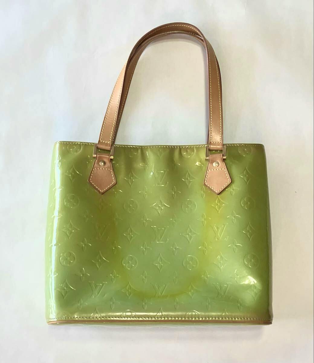Green Louis Vuitton Vernis Houston tote bag with tan leather handles shown on a white background.