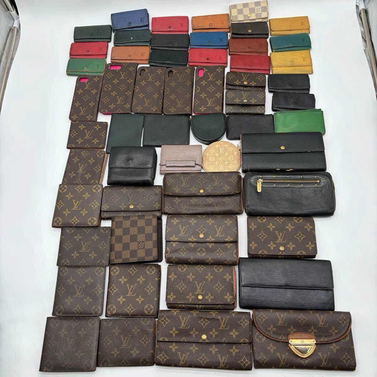 Many Louis Vuitton wallets, key cases, coin purses, and smartphone cases in monogram, Damier, and colored Epi styles arranged flat on a white background.