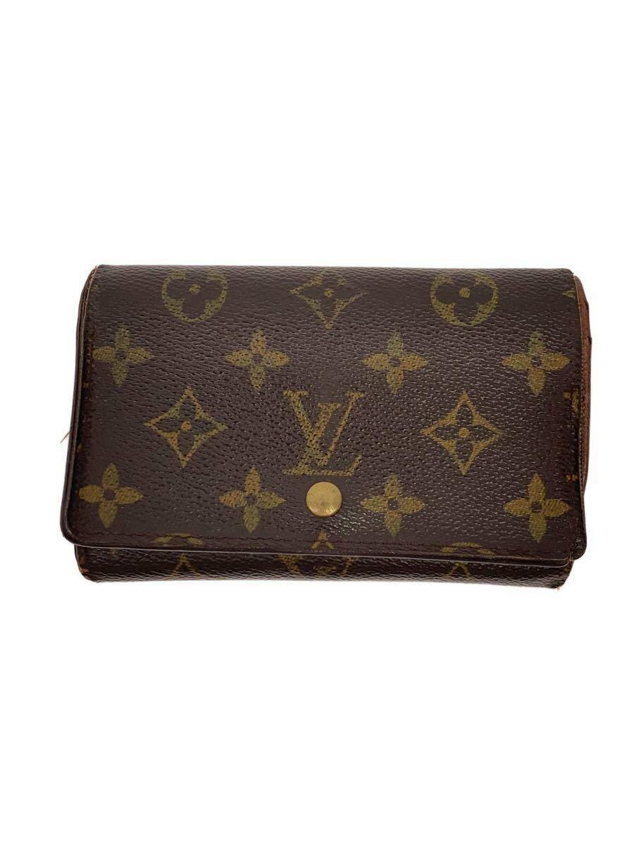Closed brown Louis Vuitton monogram bi-fold wallet shown front facing with a central snap button.