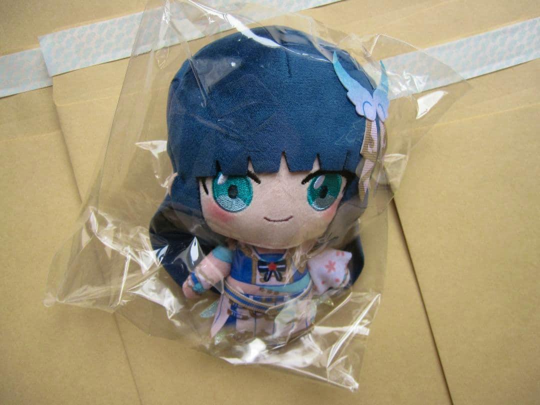 Front view of the Komagata Hanabi (Do da doing) plush toy inside a clear plastic bag on a cardboard background.