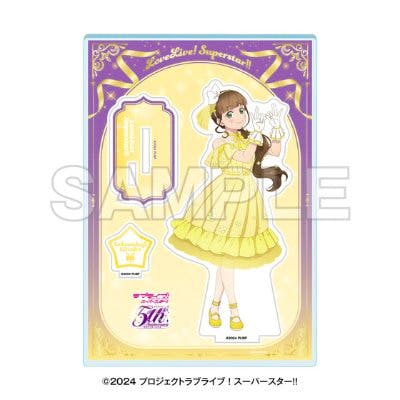 Product render of an acrylic character stand showing a girl in a yellow dress with a matching star-shaped base on decorative backing.