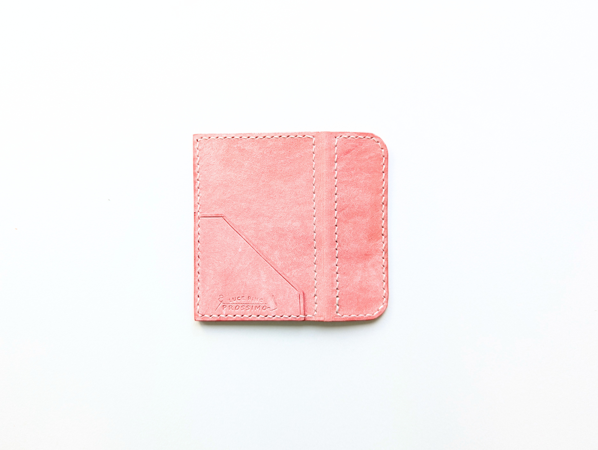 Pink leather memo stocker/book cover laid flat on a white background showing a corner pocket and visible stitching.