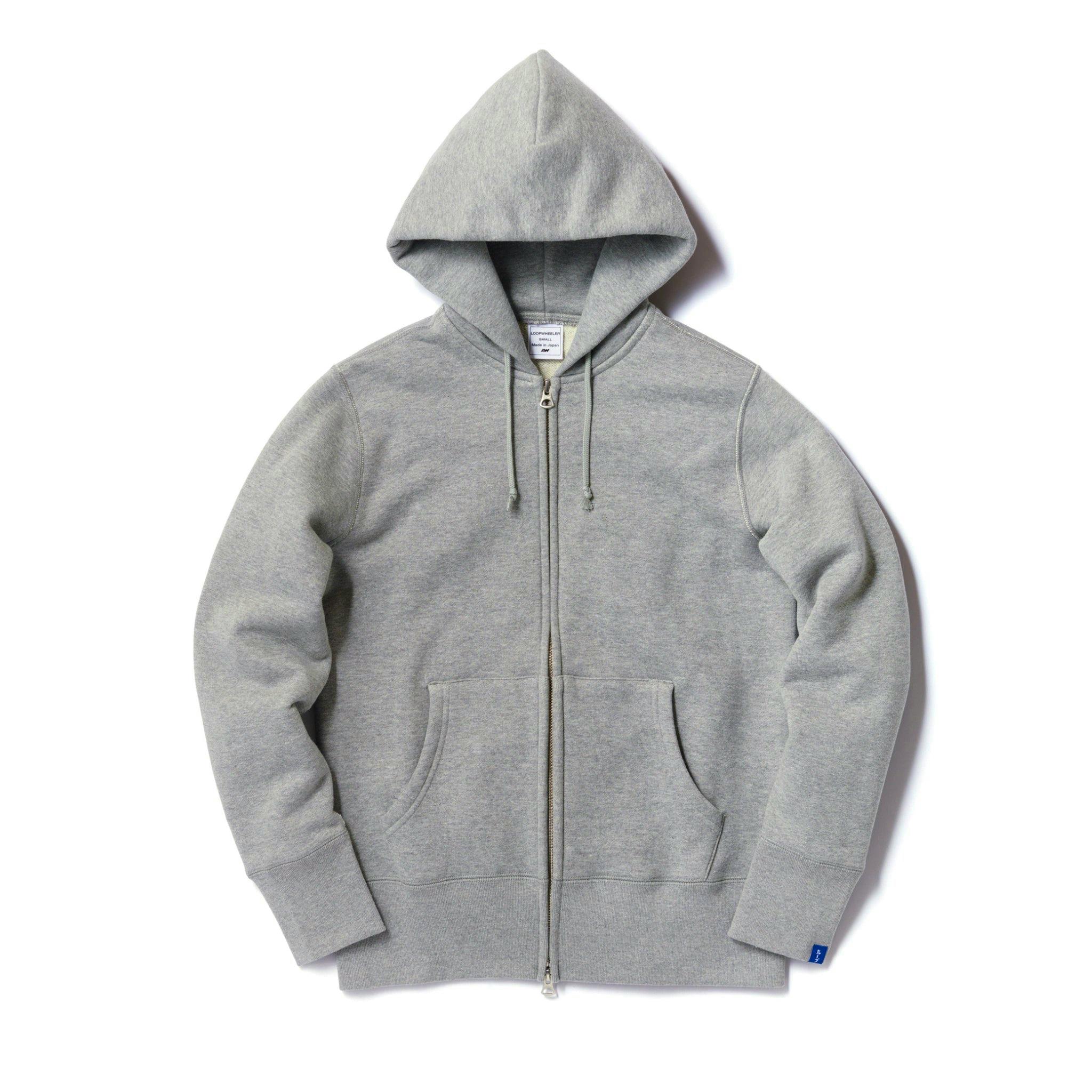 Flat-lay front view of the gray melange tubular zipper hoodie showing the hood, center zipper, kangaroo pocket, and ribbed cuffs.