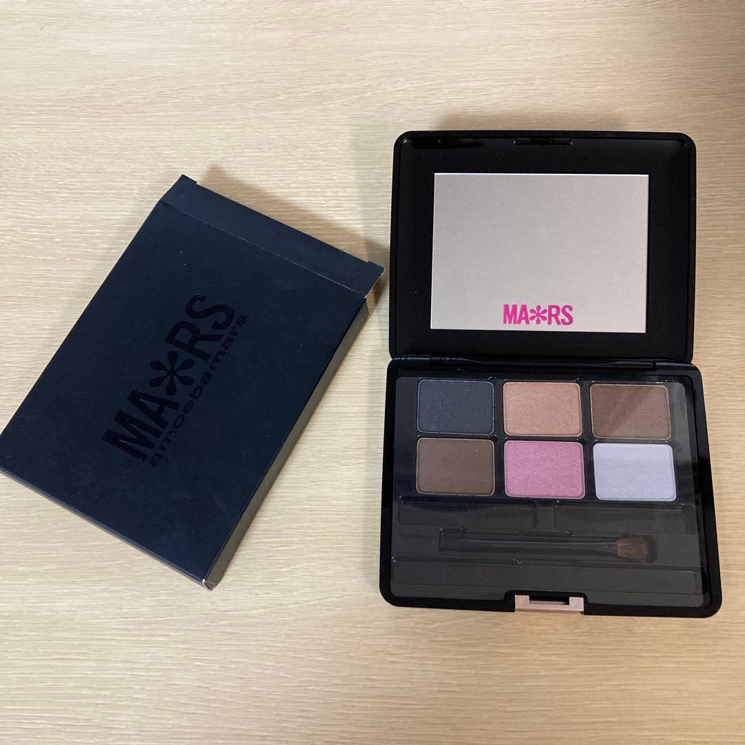 Opened MA*RS Sweet Eyes eyeshadow palette showing six pans, applicator, mirror, and the product box beside it.