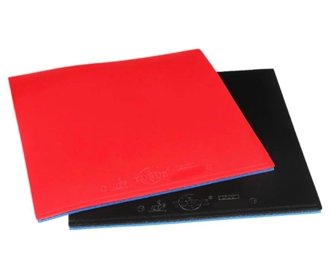 Two table tennis racket rubbers (one red, one black) stacked with surfaces and edges visible.