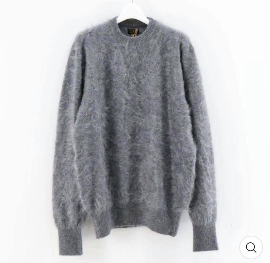 Gray shaggy cashmere sweater (MAATEE&SONS) hanging on a white hanger against a white background.