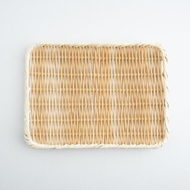 Top-down view of a rectangular woven bamboo strainer showing its woven base and wrapped rim.