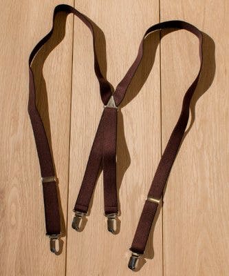 Brown X-style 20mm polyester suspenders with metal clips laid flat on a wooden floor.