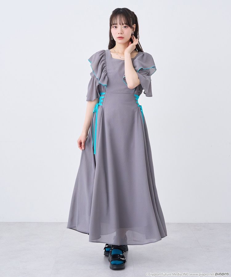 Model wearing a gray Hatsune Miku–inspired polyester dress with ruffled sleeves and teal ribbon side details.